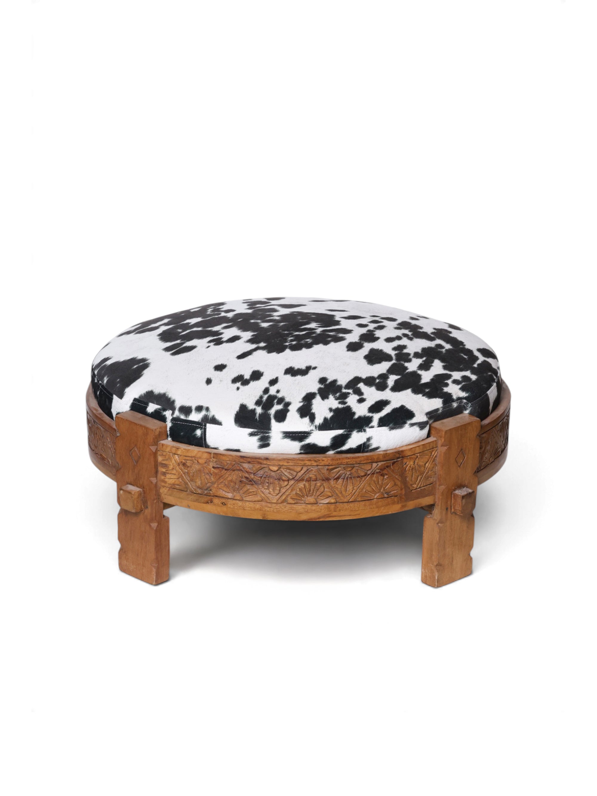 Macchiato Qahwa Ottoman by Maison Mishmashi in black and ivory cowhide print with carved wooden frame, front view